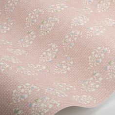 a pink wallpaper with white and blue flowers on it's back side,