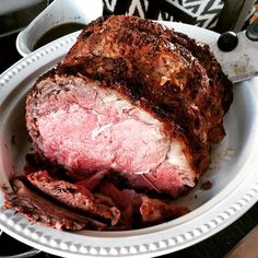 a large piece of meat sitting on top of a white plate