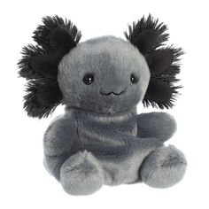 a gray stuffed animal with black feathers on it's head and eyes, sitting upright