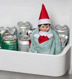 an elf is sitting in the fridge with cans