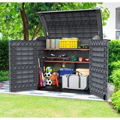 an outdoor storage shed with its doors open and various items in the compartment inside it