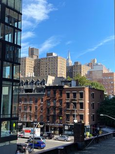 the city is full of tall buildings and cars parked on the side of the road