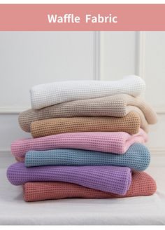 the waffle fabric is stacked on top of each other in different colors and patterns