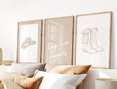 three framed pictures hang on the wall above a bed