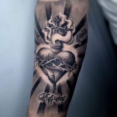 a man's arm with a cross, heart and crown tattoo design on it