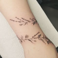 a woman's arm with a flower tattoo on it