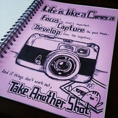 a spiral notebook with an image of a camera on the front and back cover that says, life is like a camera