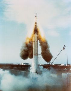 an old photo of a rocket launching into the sky