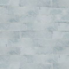 a white tile wall with grey grouting