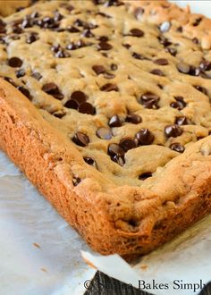 a chocolate chip cookie bar sitting on top of wax paper