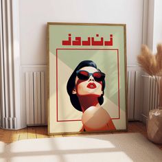 a poster with a woman's face and sunglasses on the wall next to a plant