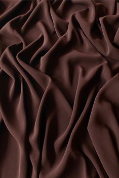 Distinguished by its luxurious design, our high-quality Chocolate Triacetate Lightweight Matte Crepe fabric is perfect for evening wear, skirts, blouses, pants, shirts, jackets. Originally made in Japan, this exceptionally versatile fabric is the perfect choice for your next projects. Our unique and distinctive fabric is available in a wide selection of colors. Purchase high-quality Triacetate Lightweight Matte Crepe fabric by the Yard at NY Designer Fabrics. Elegant Silk Fabric For Evening, Elegant Evening Silk Fabric, Banana Crepes, Crepe Material, Luxurious Design, African Design Dresses, Brown Fabric, African Design, Crepe Fabric