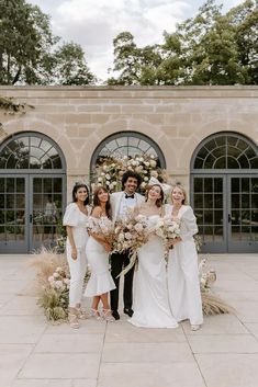 a group of people standing next to each other in front of a building