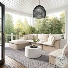 an outdoor living room with white furniture and wood flooring