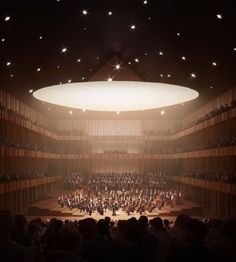 an auditorium filled with lots of people on stage and in front of a large circular ceiling