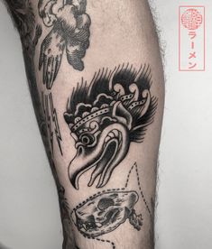 a man's leg with tattoos on it and an image of a bird in the background