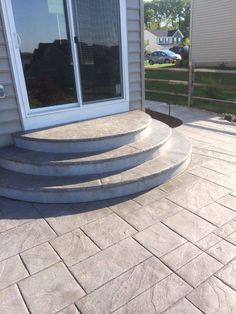 a patio with steps leading up to the front door