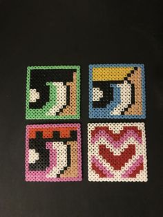 four coasters made out of perler beads on a black surface with the word love spelled in different colors