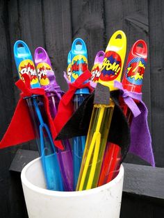 a cup filled with lots of different colored umbrellas