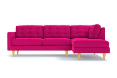 a pink sectional sofa with wooden legs