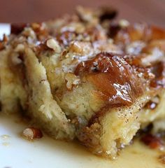 a piece of cake sitting on top of a white plate covered in caramel sauce