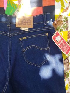 "High waist Lee brand womens dark blue denim mom jeans. New old stock with tags. Size 16L but modern sizing makes them closer to 10/12. Full curvy straight leg fit with zip fly. Lee brand stamp on the grommets. Some age coloring on leather Lee tag and the inside lining of pockets but no other stains or holes. Excellent vintage condition. Iconic gold yellow stitching. Medium weight denim with a little stretch. measured flat waist 15.5\" front rise 13\" thigh 12\" inseam 33.5\"" Hawaiian Print Dress, Brand Stamp, Dark Blue Denim, Lee Jeans, Hawaiian Print, Star Dress, Womens Jeans, Star Shirt, Blue Shirt