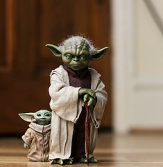 the child yoda and baby star wars doll are posed for a photo on the floor