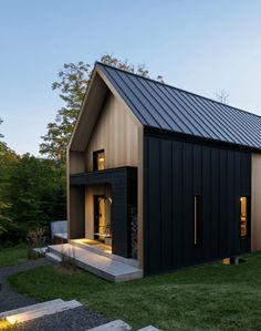 a small house in the middle of a grassy area with stairs leading up to it