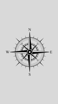 a black and white compass with the word w e s on it's side