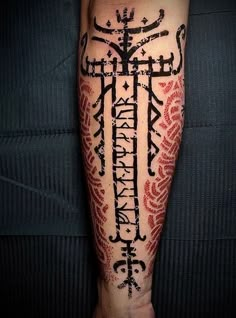 a person with a cross tattoo on their arm and leg is shown in black ink