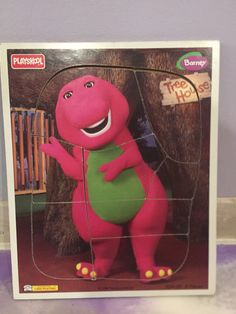 a cardboard box with the image of a pink dinosaur