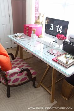 a desk with a chair, computer and other items on it