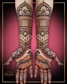 two hands that are decorated with henna and designs on them, one is holding the other