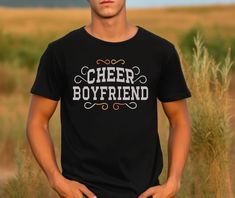 "Celebrate your cheerleader boyfriend's spirit with our exclusive \"Cheer Boyfriend\" unisex t-shirt! Crafted for comfort and style, this tee is the perfect way to show off your pride and support for your cheerleading partner. Key Features: 🎀 Comfortable Unisex Fit: Made from soft, breathable fabric, this t-shirt ensures all-day comfort. 📣 Unique Design: Stand out in the crowd with our exclusive \"Cheer Boyfriend\" typography, perfect for proud cheerleading supporters. 🎁 Great Gift Idea: Surp Cheer Boyfriend, Design Stand, Boyfriend Tee, Nicaragua, Honduras, Cheerleading, Unisex T Shirt, Breathable Fabric, Unique Design