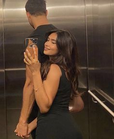 a man and woman standing in front of an elevator