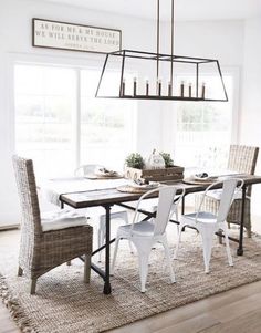 a dining room table with chairs and a chandelier hanging from it's ceiling