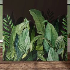 a wall mural with green leaves on it in a dining room or living room area