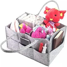 an open gray bag filled with lots of toys and other items on top of a white background