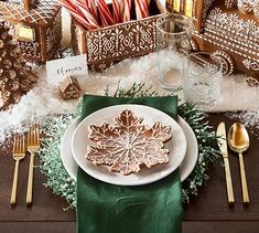 a white plate topped with cookies on top of a wooden table next to christmas decorations