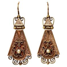 A spectacular pair of early Antique Victorian 14 Karat Gold Articulated Pendant Earrings with stunning engraving throughout. Further enhanced with applied filigree work with pearl accents. The earrings are articulated - the top triangle is hinged so the lower pendants always hang perfectly! The beautiful Etruscan Revival gold work is of the highest quality. They are a wonderful size - large enough to be dramatic but not overwhelming! The earrings date to circa 1860-1890. The earrings are 1 3/4 inches (46mm) long including the hook portion. Without the hooks they are 36mm tall and 16mm wide. Together they weigh 5.6 grams. Gold Pendant Earrings, Victorian Drop Earrings, Pearl Pendant Earrings, Vintage Drop Earrings, Contemporary Earrings, Picasso Jasper, Jasper Earrings, Diamond Dangle Earrings, Victorian Gold