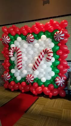 a large balloon frame decorated with candy canes and candies