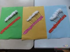 four different colored toothbrushes with clouds on them