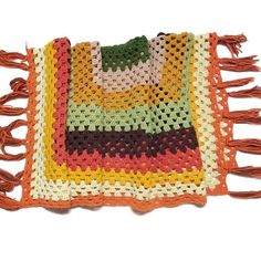 a multicolored crocheted rug with tassels