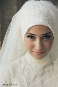 a woman wearing a white veil and green frame