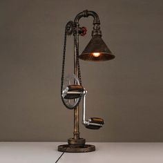 an old fashioned desk lamp is turned into a table lamp with a pull chain attached to it