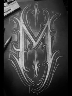 the letter m is drawn on a piece of paper