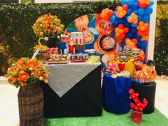 a table topped with lots of food and balloons