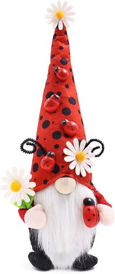 a red and white gnome figurine with daisies on it's head