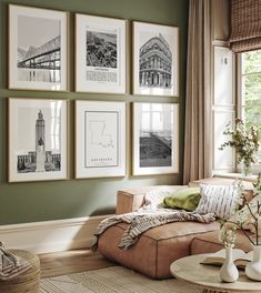 a living room with green walls and pictures on the wall above the couch, along with a coffee table