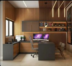 a home office with two computers on the desk